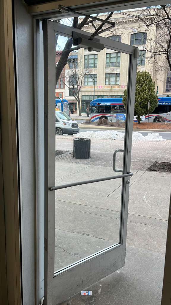 Commercial door closer on glass entry door.